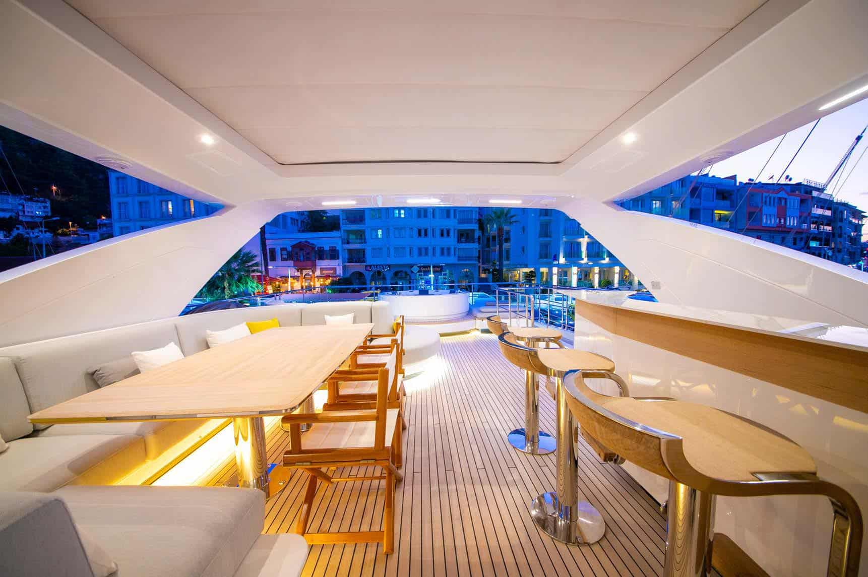 Azimut Grande 27M flybridge dining and bar at dusk, broker photo
