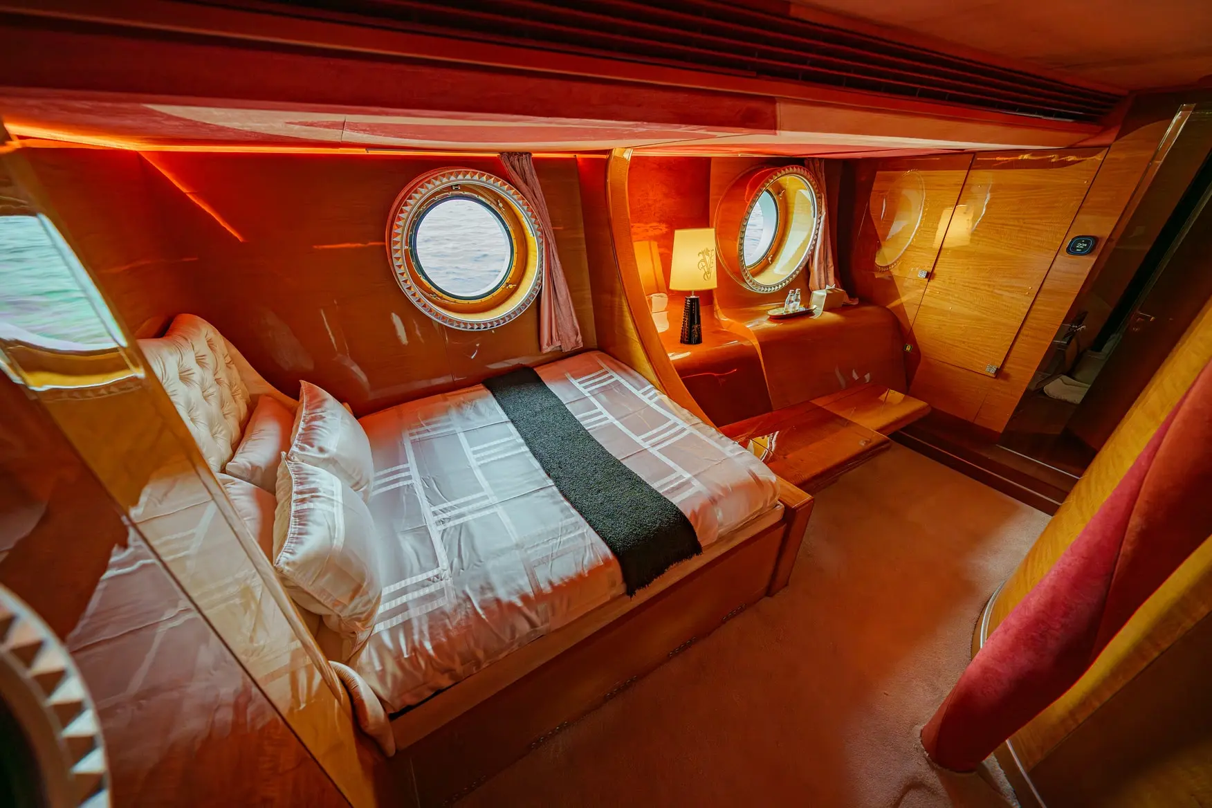 Thunder Superyacht twin bed cabin with wooden interior and round window