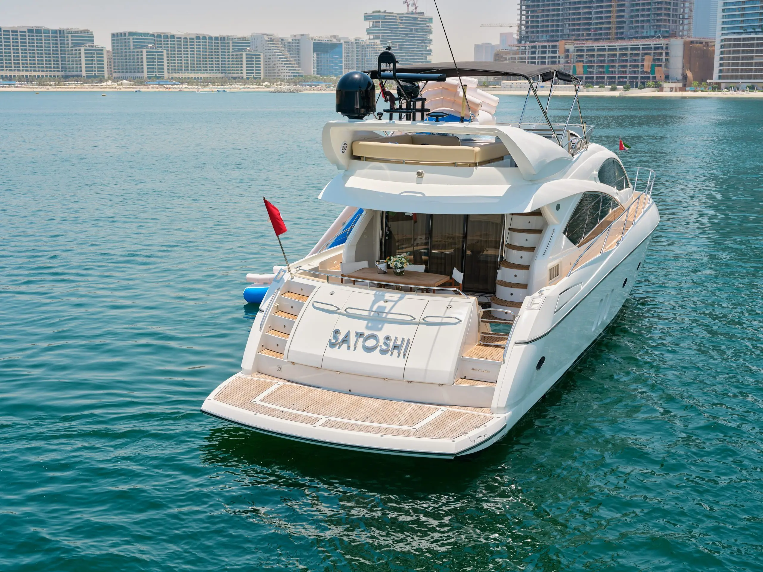 Sunseeker Satoshi 70 luxury yacht aft view cruising