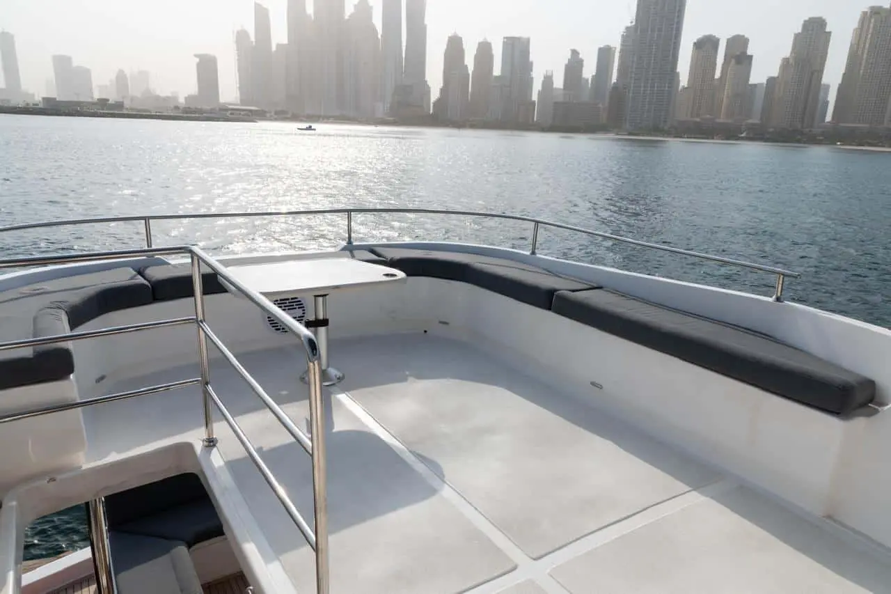 Forward deck seating area of Zenith 64 yacht with Dubai skyline