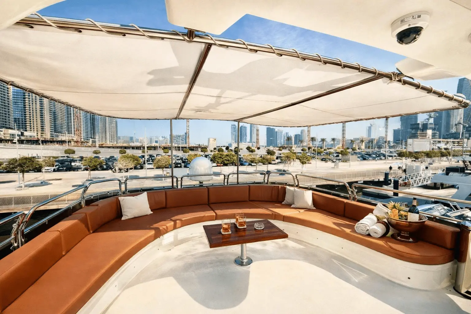 Benetti 120 flybridge lounge with shaded seating and panoramic skyline view