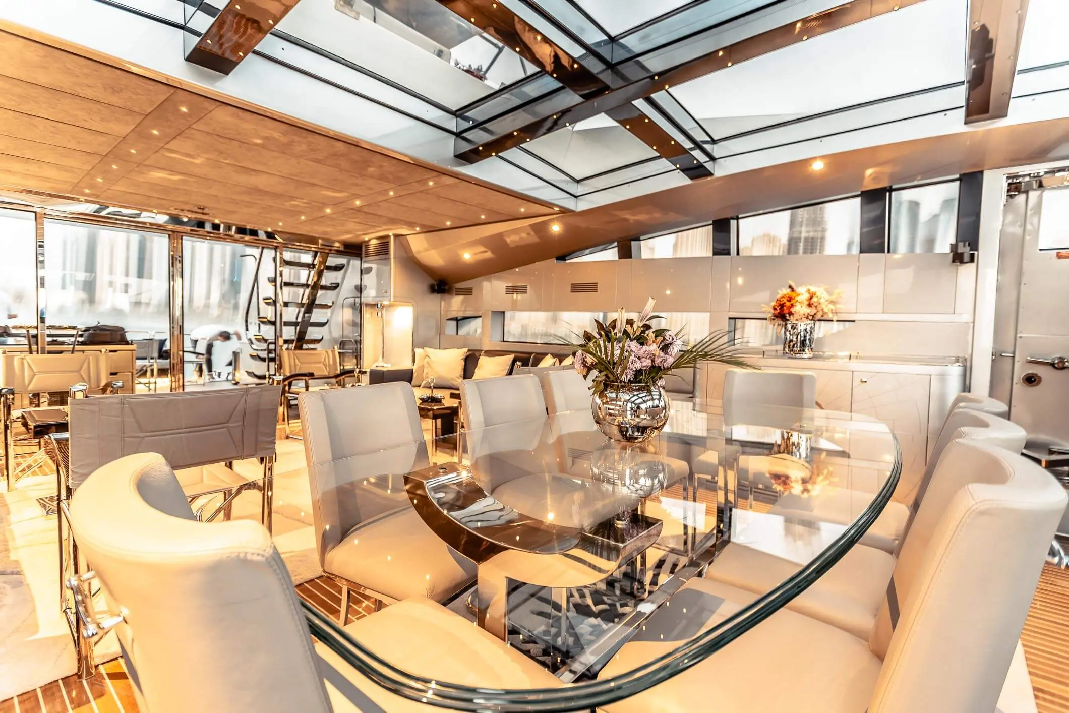 Baglietto 105 HT dining area with glass table under skylight