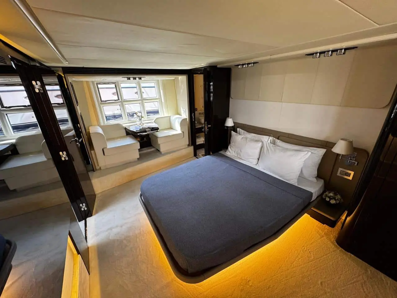 Azimut 77 yacht master bedroom with under-bed lighting and private lounge area