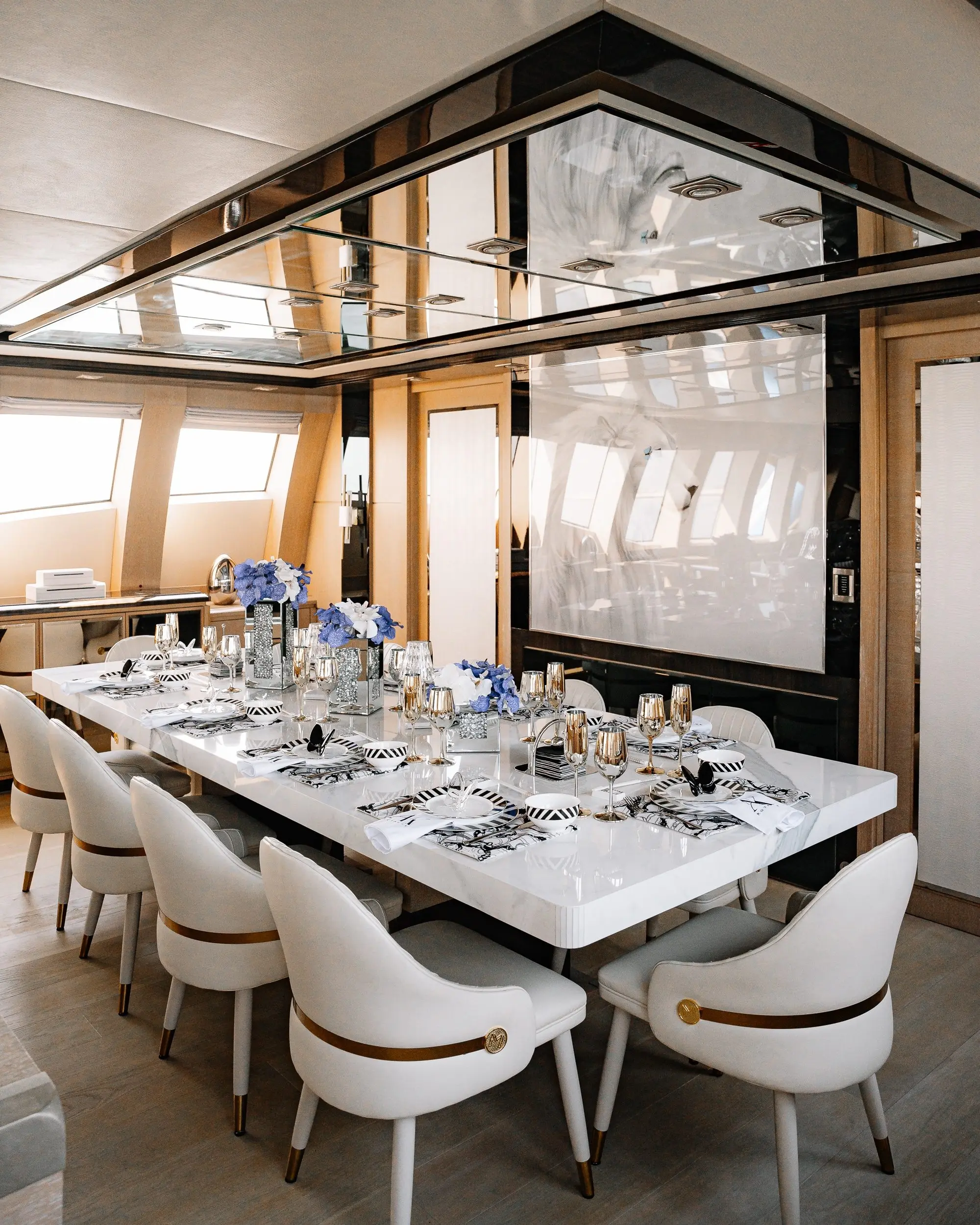 Royalty 136 luxury yacht formal dining area with elegant table setup and panoramic windows