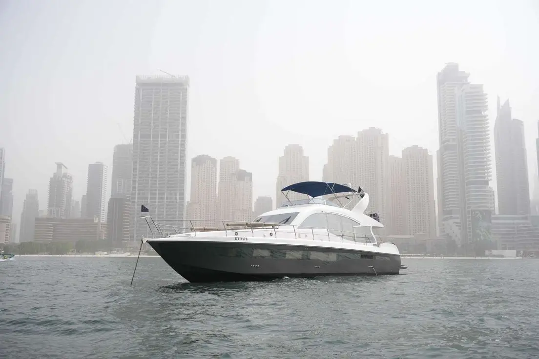 Belle 75 luxury yacht on the water with city skyline background