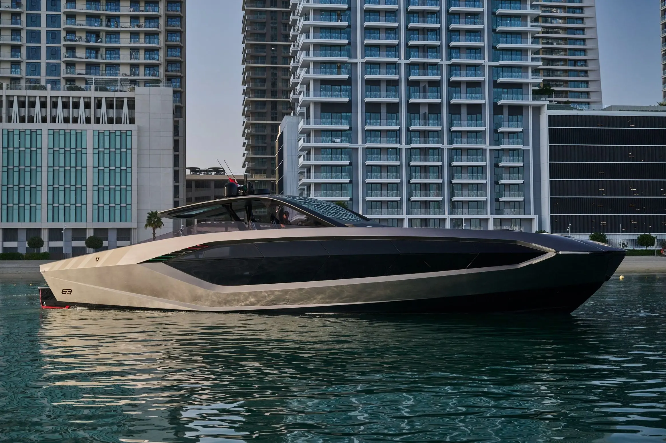 Lamborghini 63 yacht side view docked at waterfront marina with city backdrop