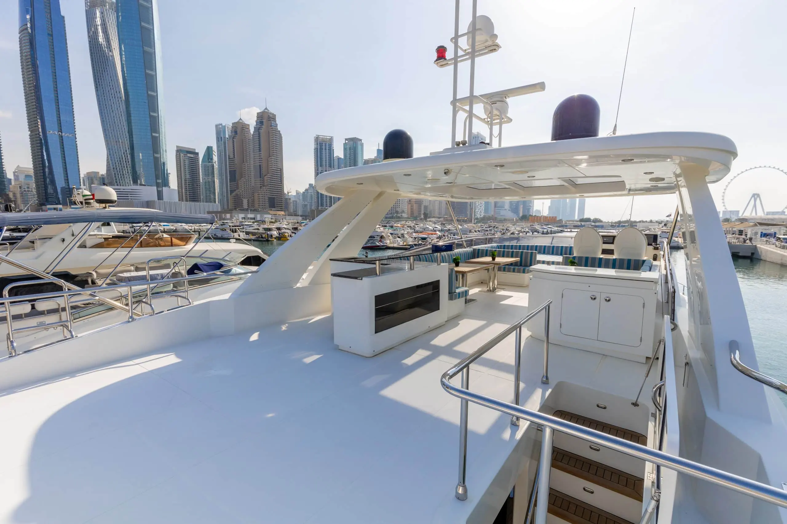 Cante 97 yacht rear deck with seating and UAE flag
