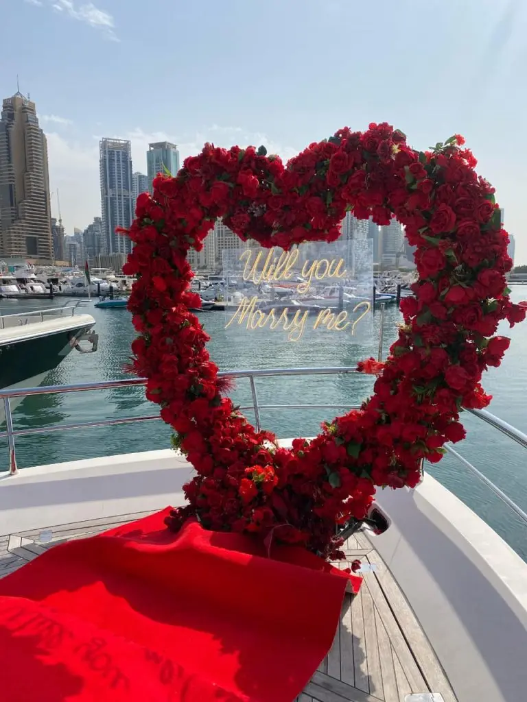 Heart-shaped red floral decoration on yacht deck for romantic proposal