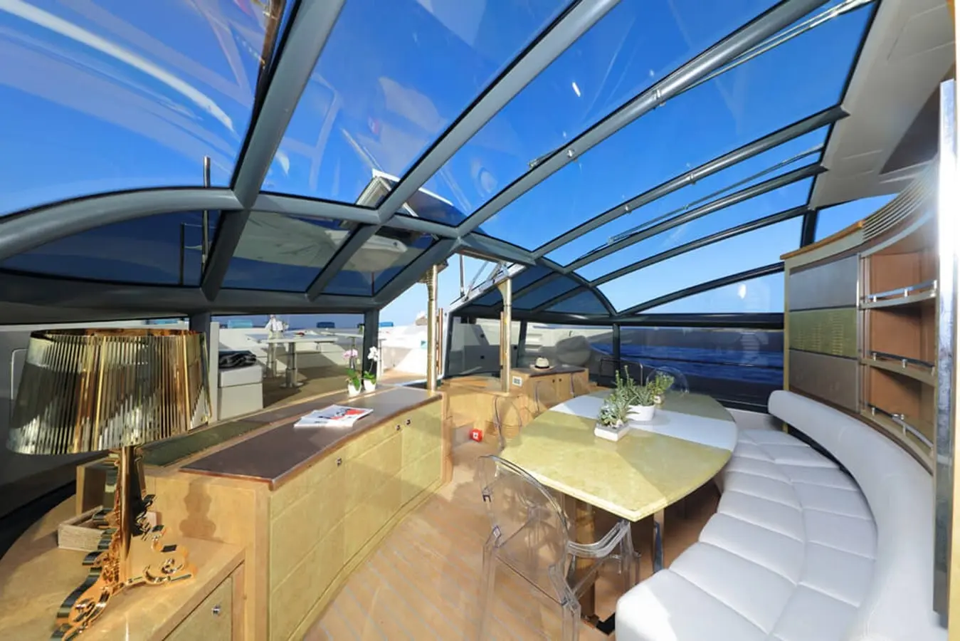 Baia 100 glass-roof main saloon with curved cream seating