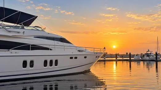 Empress 80 flybridge yacht bow at sunset, Dubai Harbour