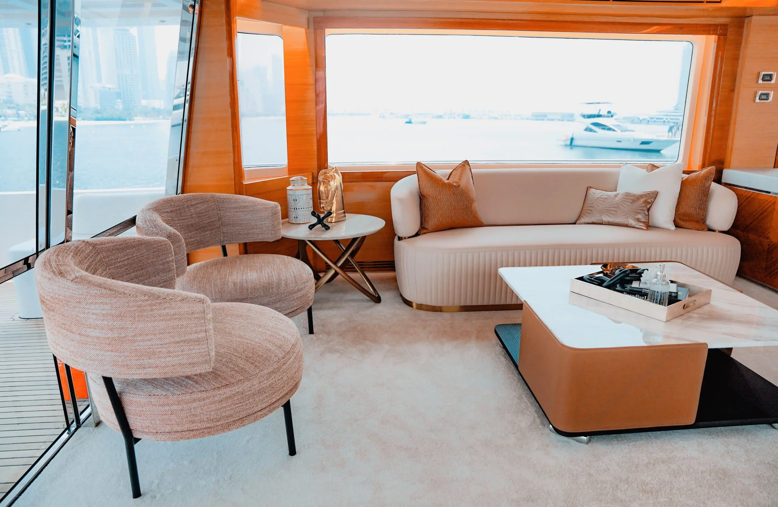 Luxury lounge seating area onboard Carina 75 yacht with curved sofa and sea views