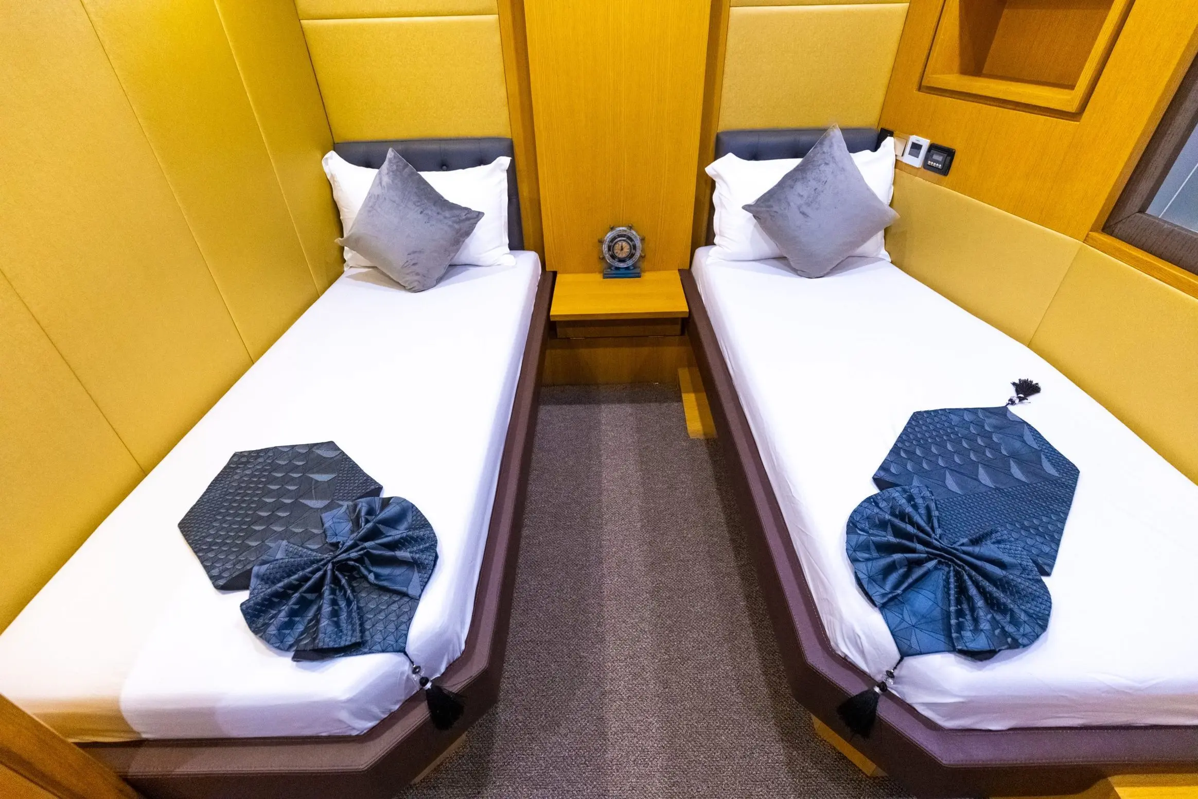 Asya 110 yacht twin guest cabin with two single beds and accent lighting