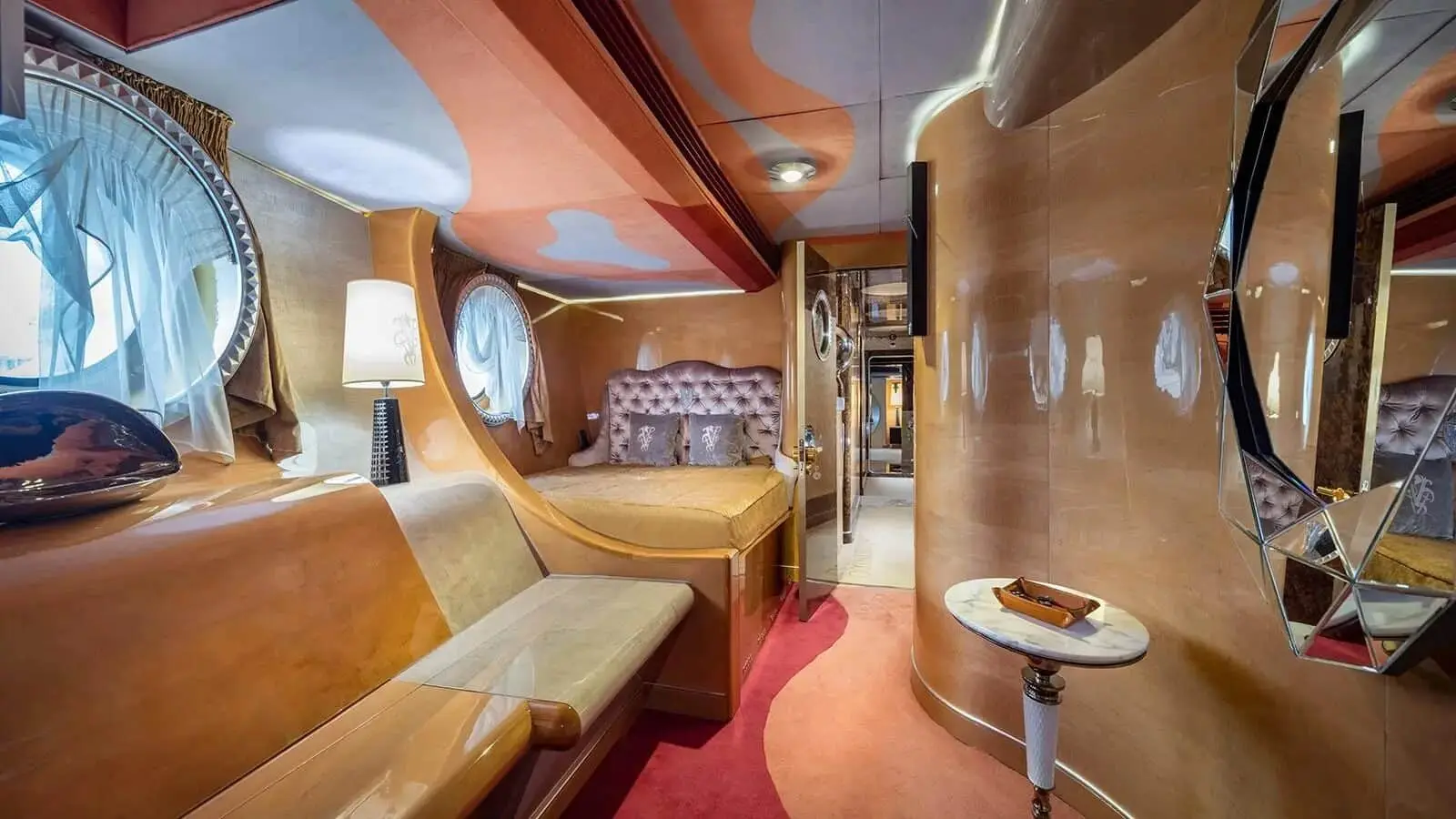 Thunder Superyacht guest cabin with elegant wooden interior and plush seating