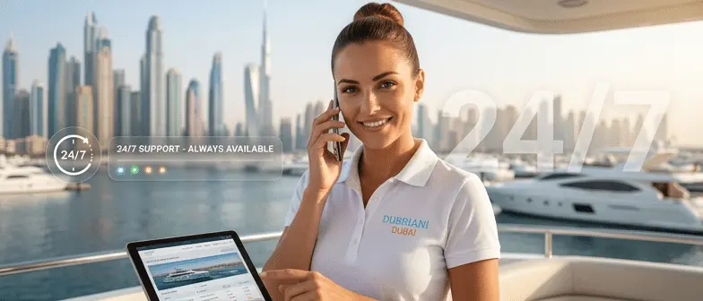 Dubriani crew member on the phone with a tablet, marina in background, 24/7 support