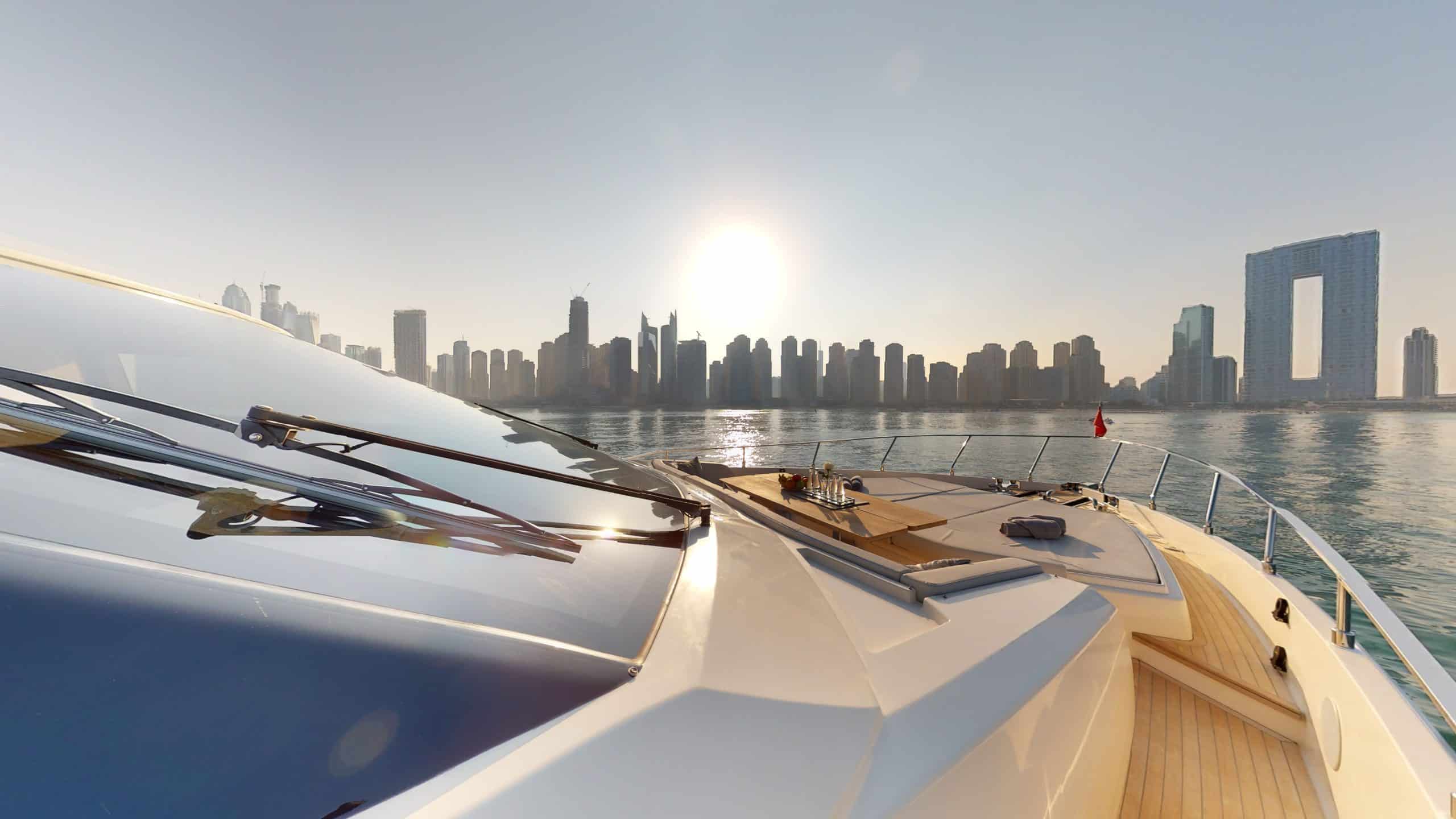 Ferretti 780 foredeck lounge area with Dubai skyline view at sunset