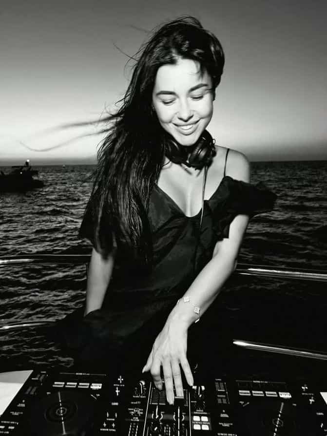 Female DJ mixing tracks live during exclusive yacht party
