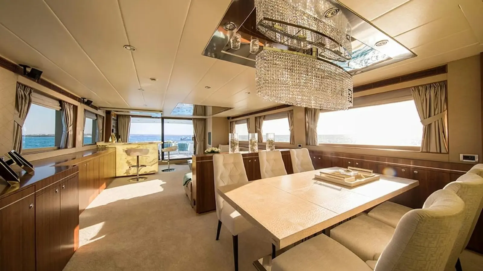 Zeta 100 yacht formal dining area with large table and sea views