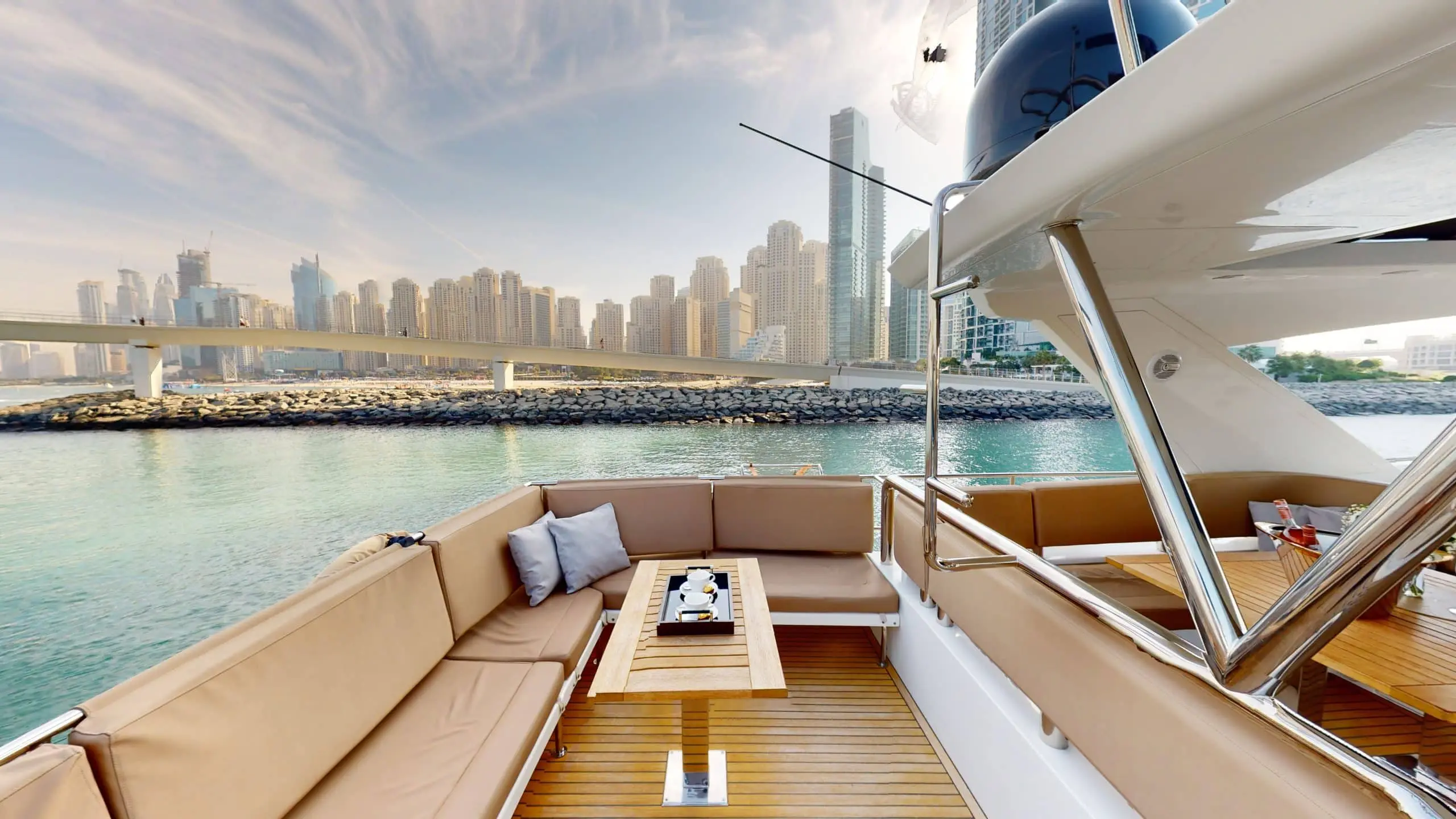 Galeon 780 F1 yacht side deck lounge area with luxury seating and skyline view