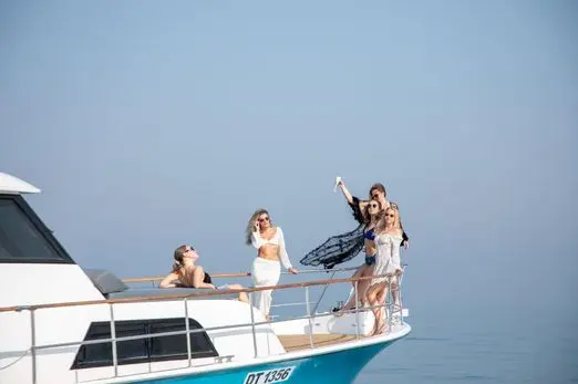 Friends relaxing and enjoying a yacht trip in Dubai