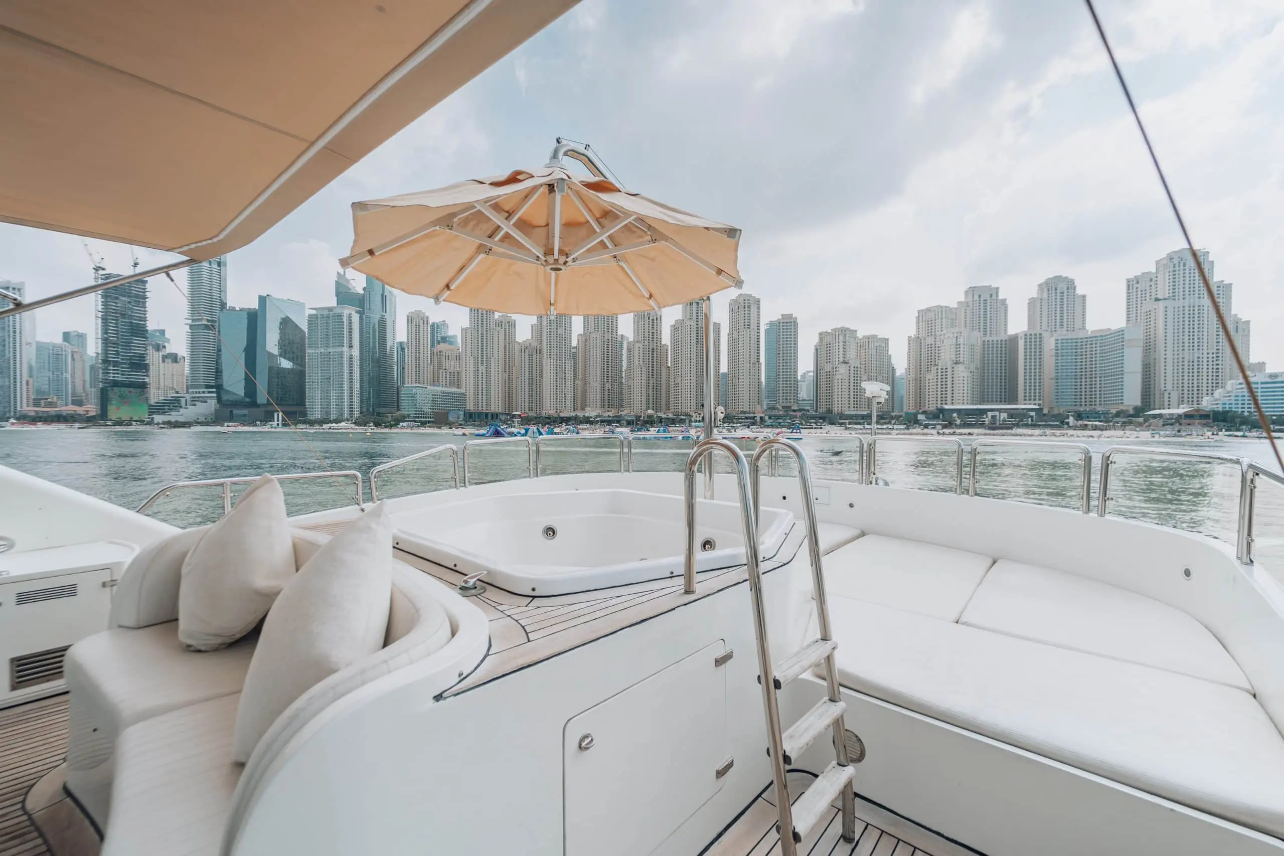 Yacht deck with jacuzzi and skyline view.