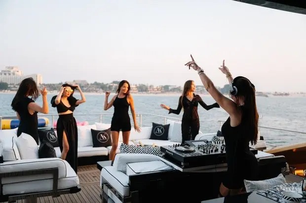 Group of women enjoying a yacht party at sunset