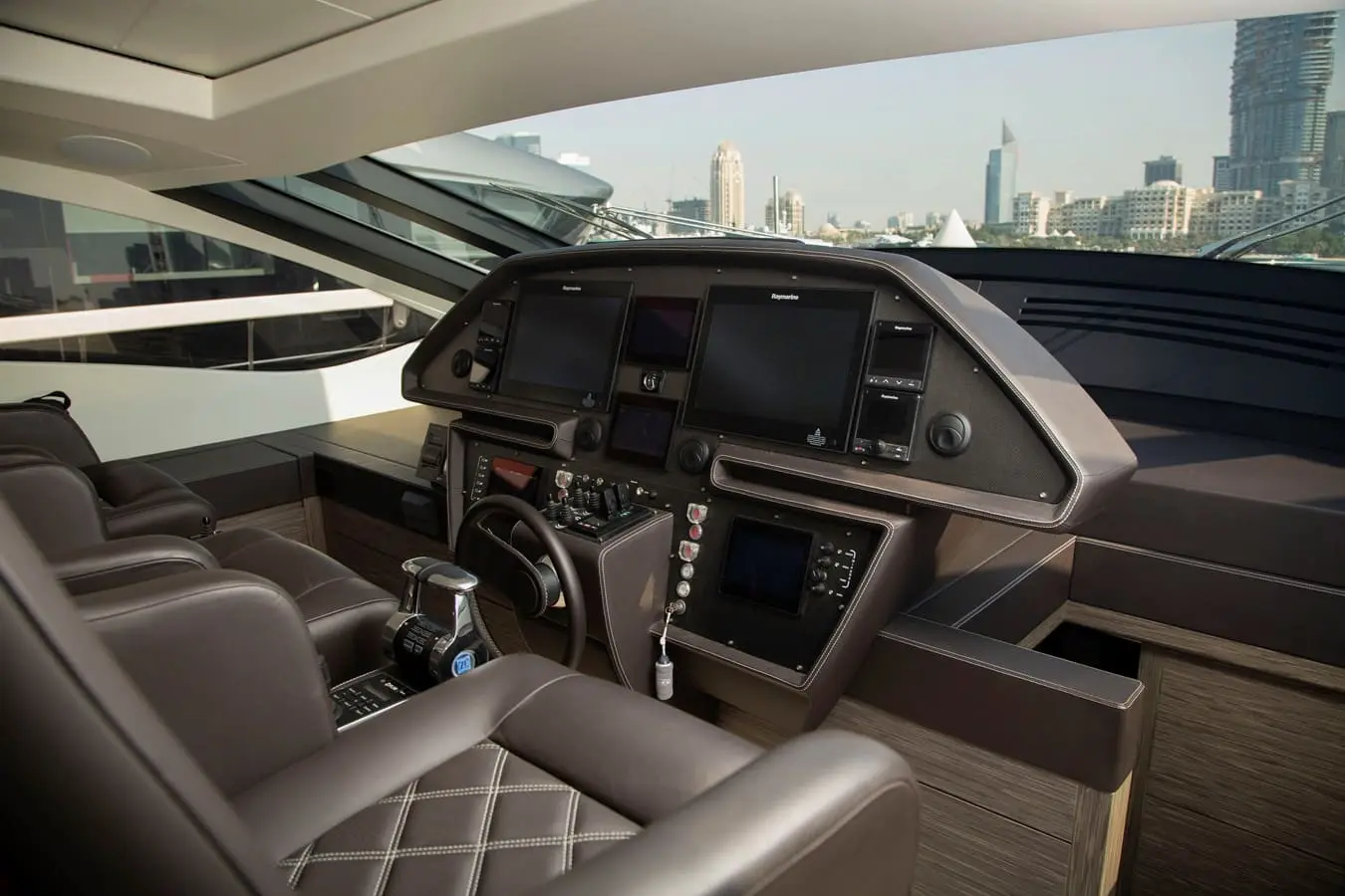 Pershing 82 main helm station with Raymarine console screens