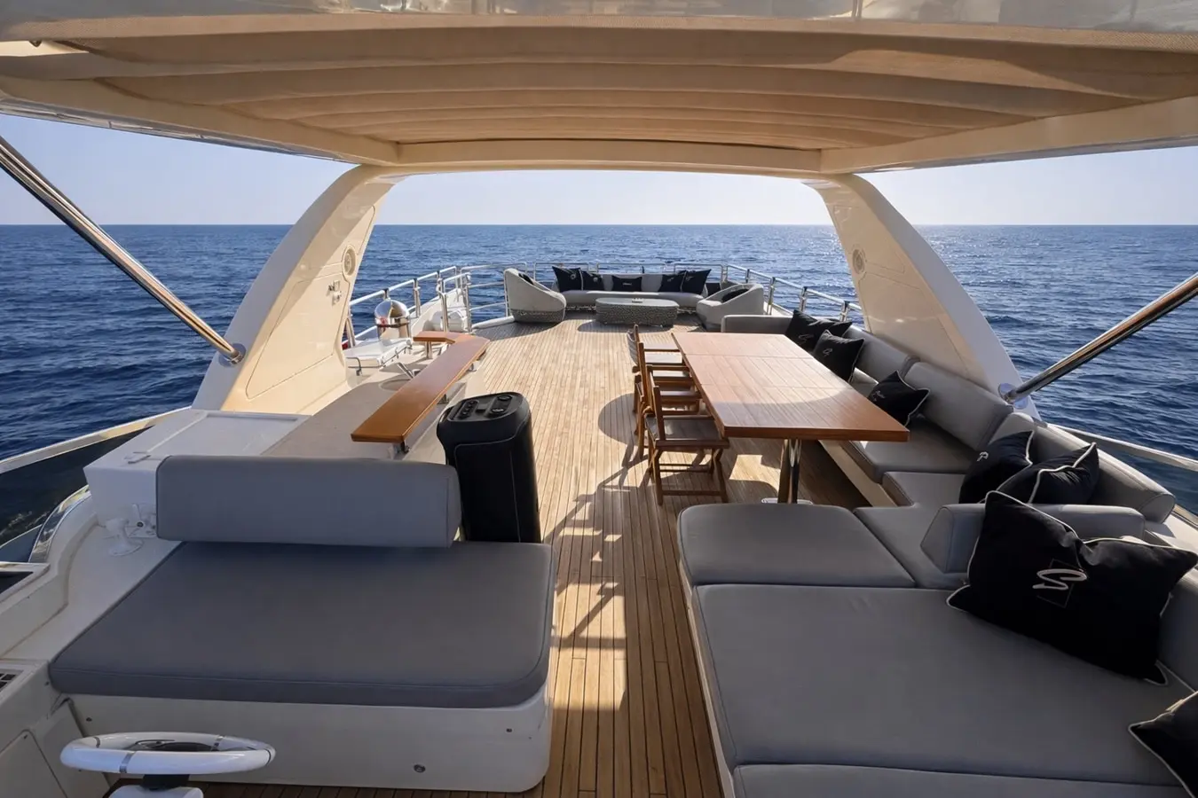 Azimut 88 flybridge dining table shaded beneath the hardtop