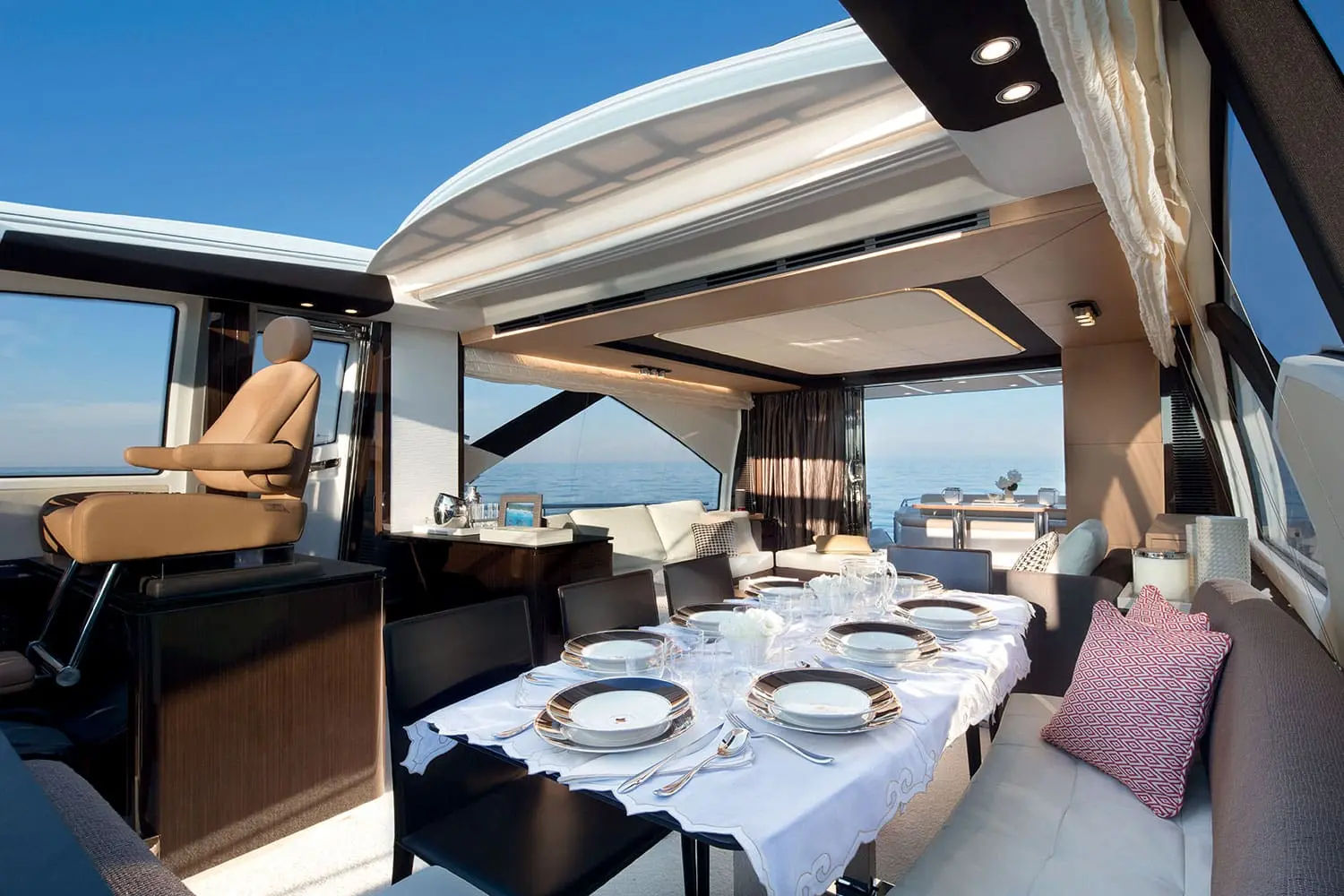 Azimut 77S dining area beside helm with hard top open — shipyard photo