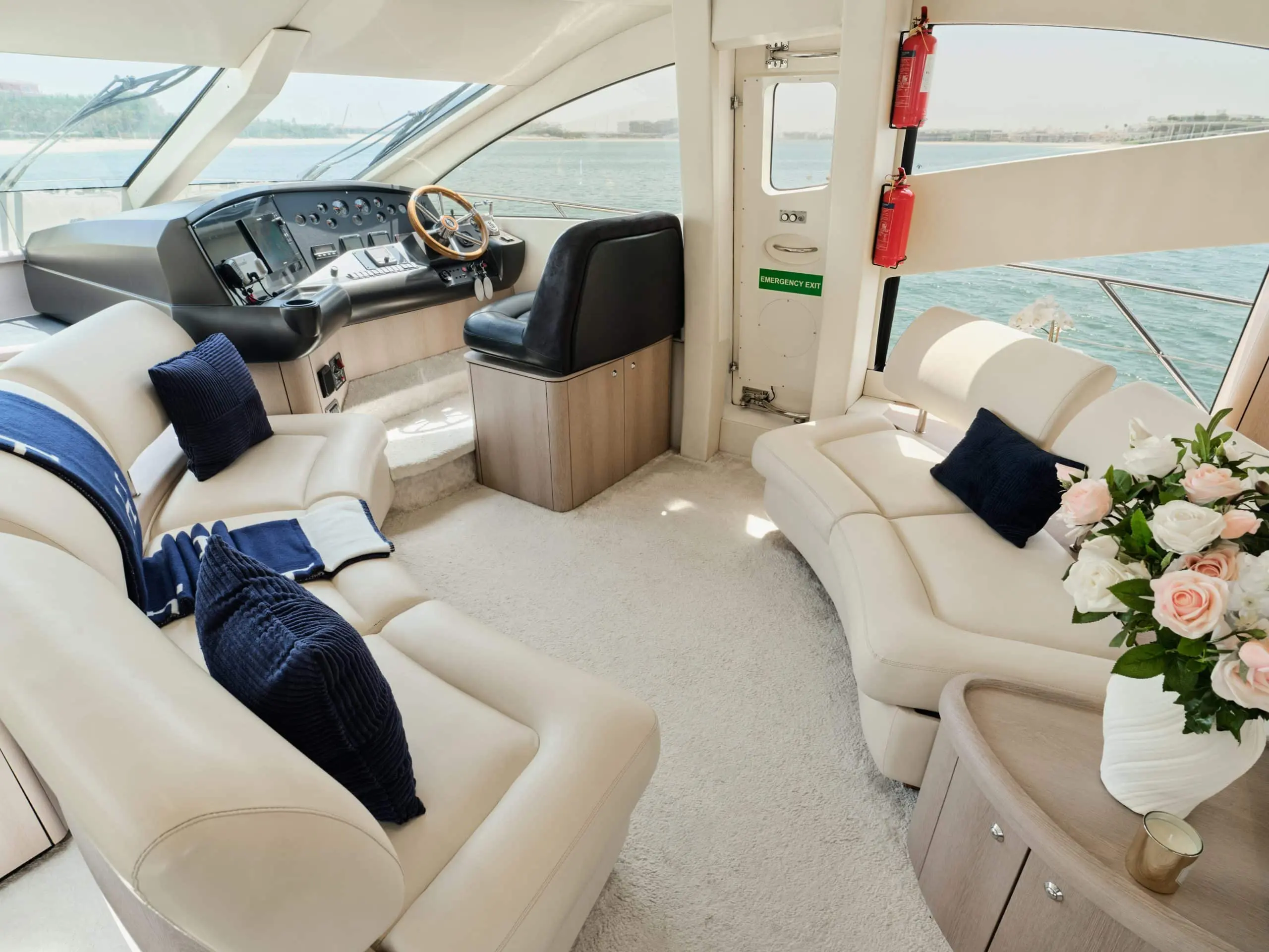 Sunseeker Satoshi 70 helm station and indoor seating area with large front windows