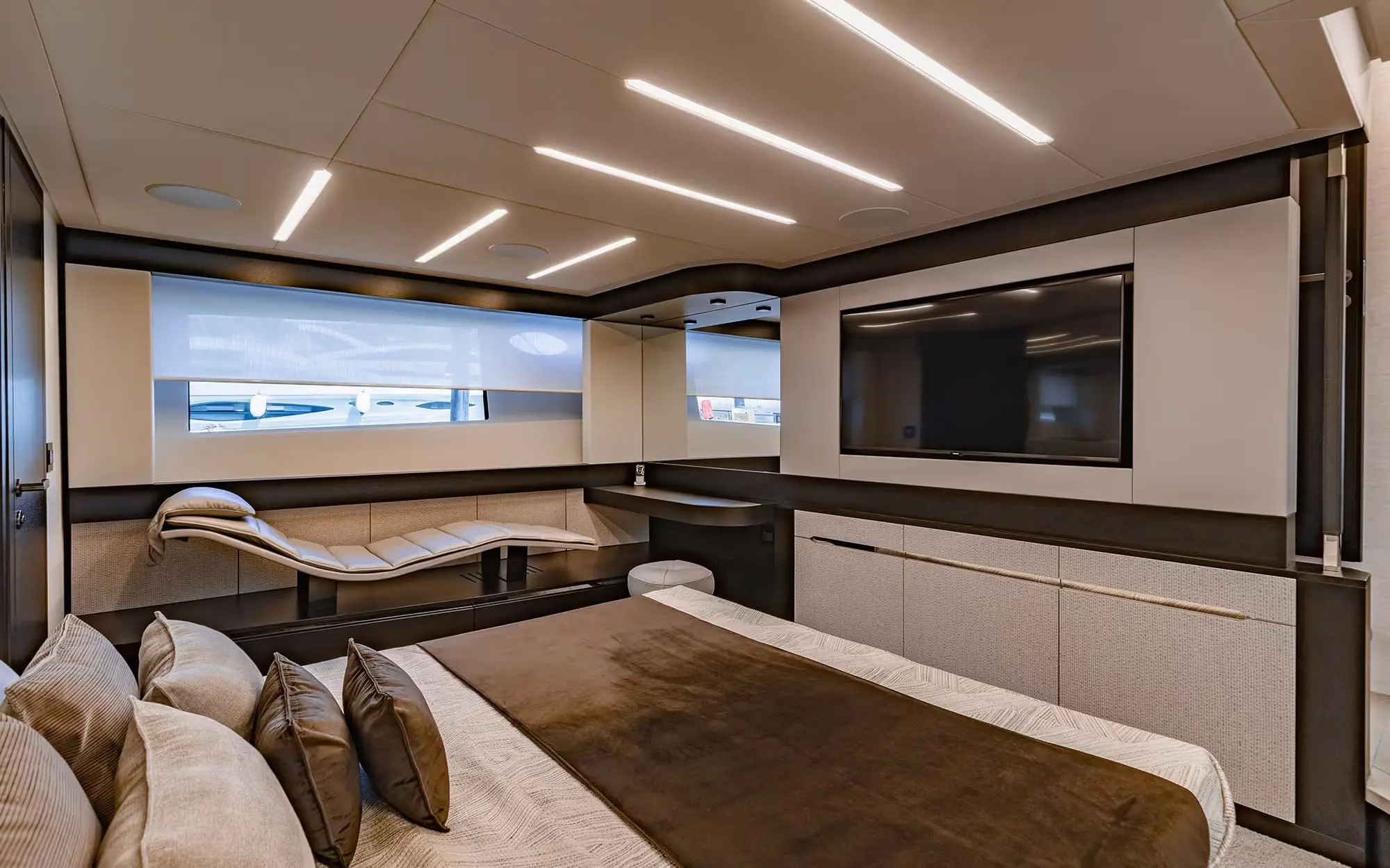 Pershing 8X guest cabin with wall-mounted television and chaise