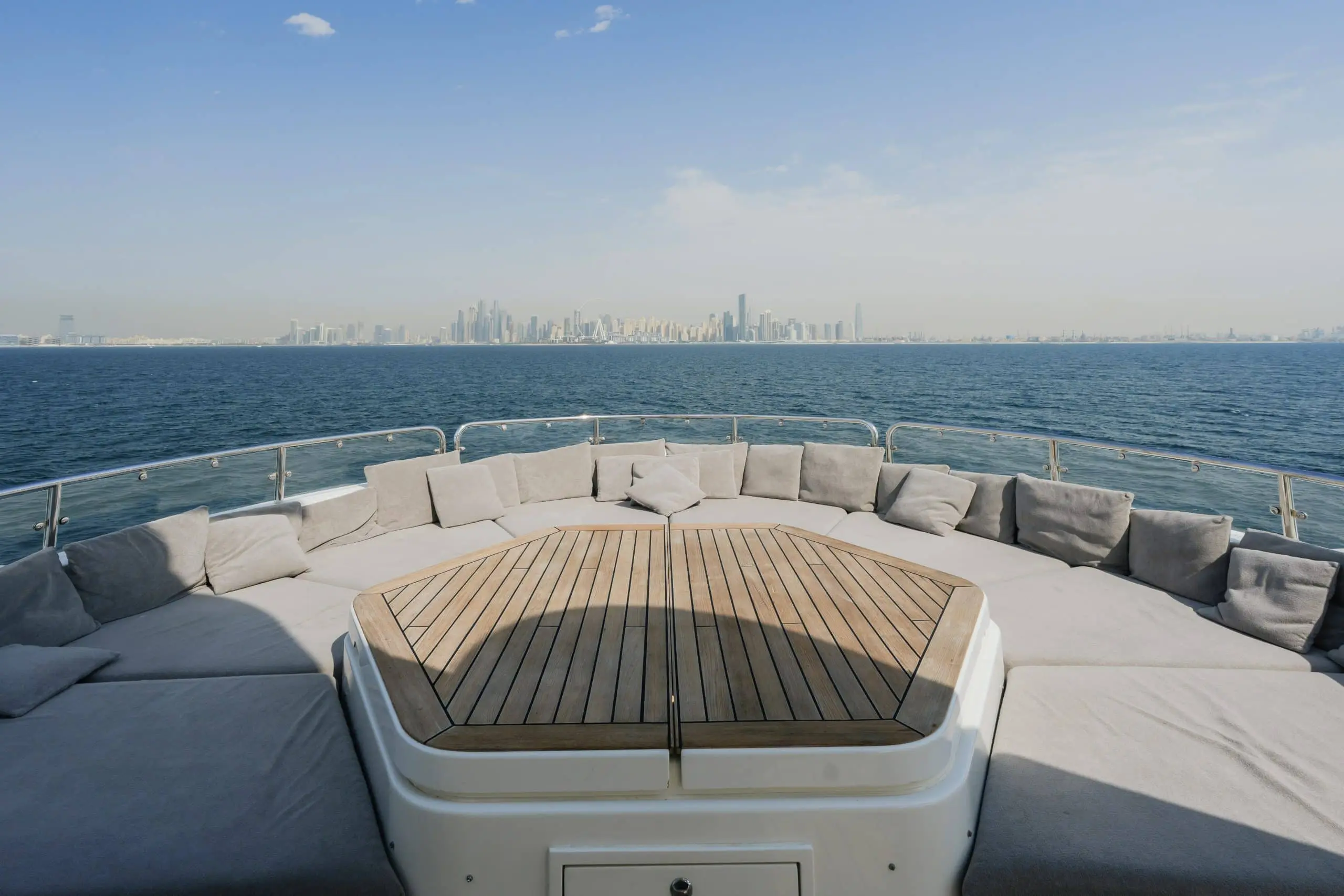 Aurora 130 yacht bow seating area with teak decking and skyline in background