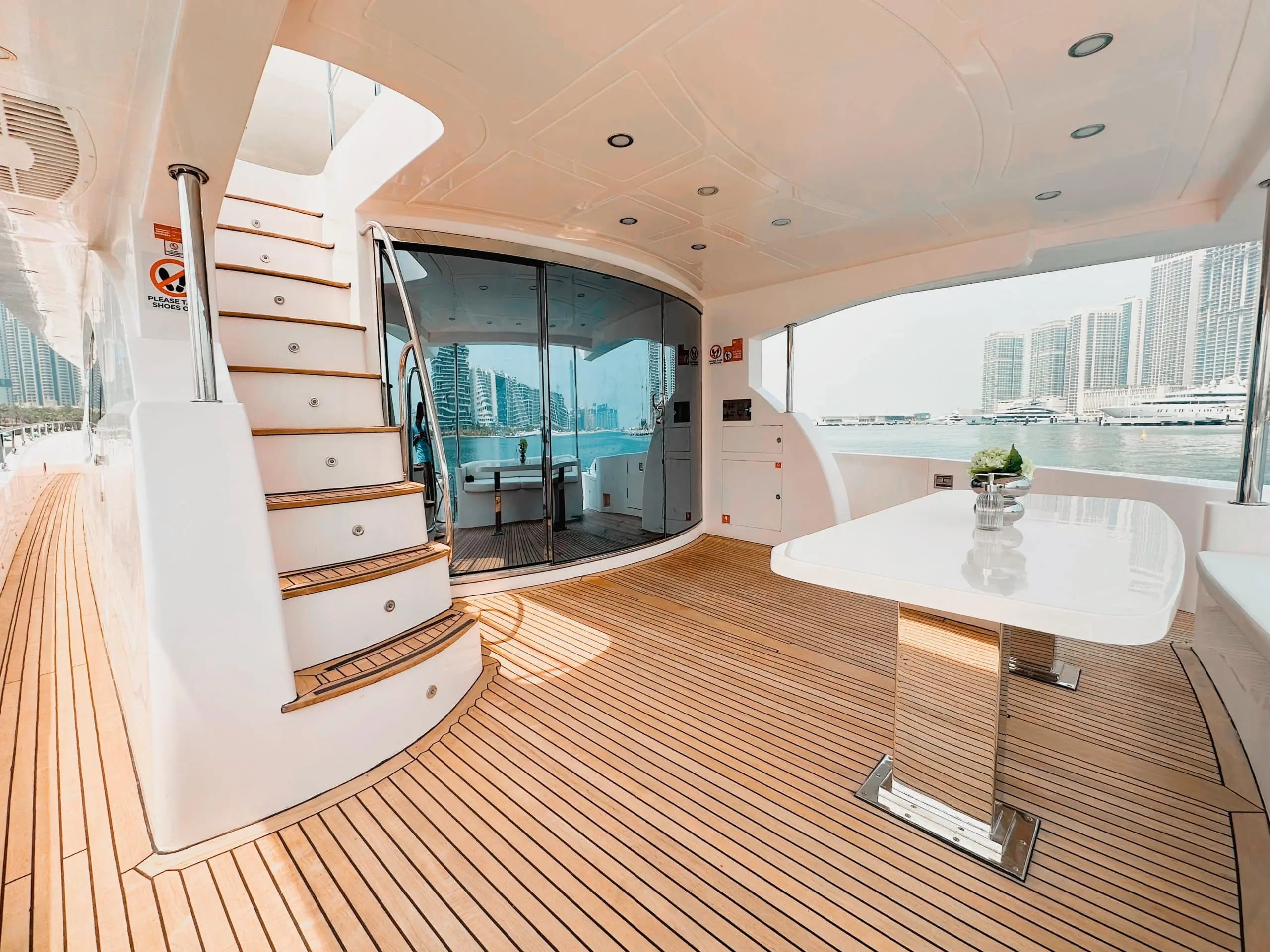 Luna 101 yacht aft deck dining area with staircase and marina view at Yas Marina Abu Dhabi