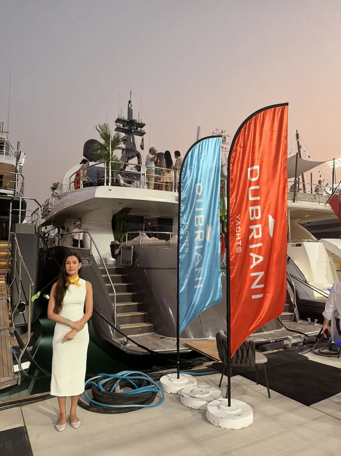 Event hostess welcoming guests during Abu Dhabi Formula 1 yacht hospitality experience