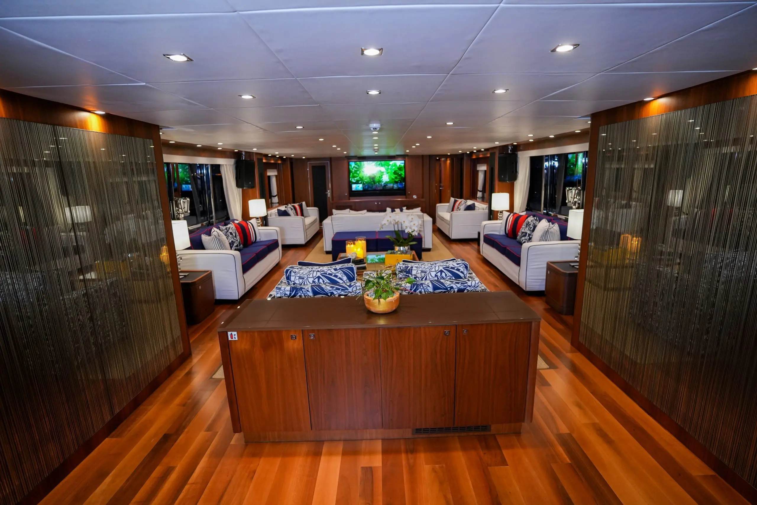 Interior bar area in Sunseeker 131 yacht main salon with polished wood flooring