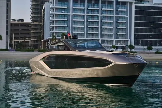 Lamborghini 63 yacht exterior profile cruising near luxury waterfront buildings