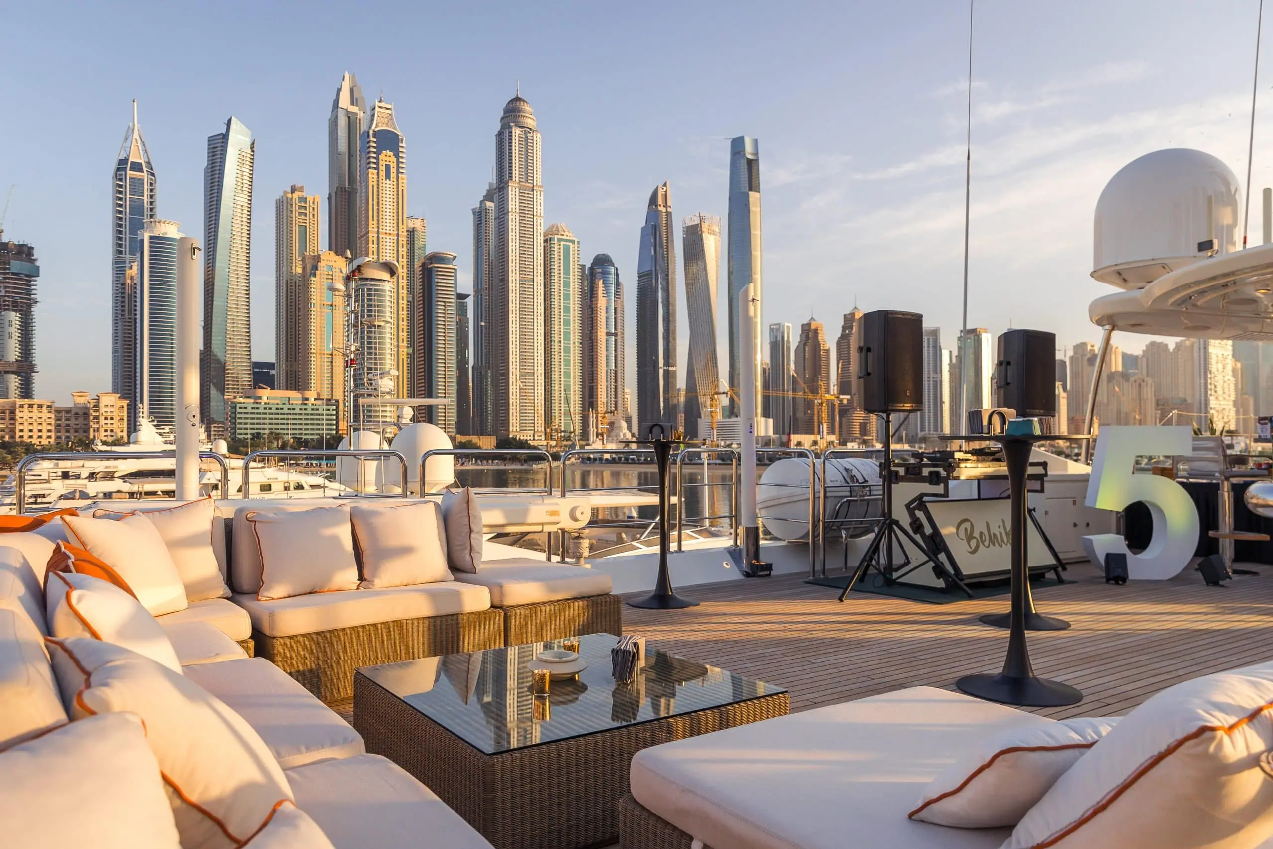 Luxury yacht lounge seating with Abu Dhabi skyline in the background