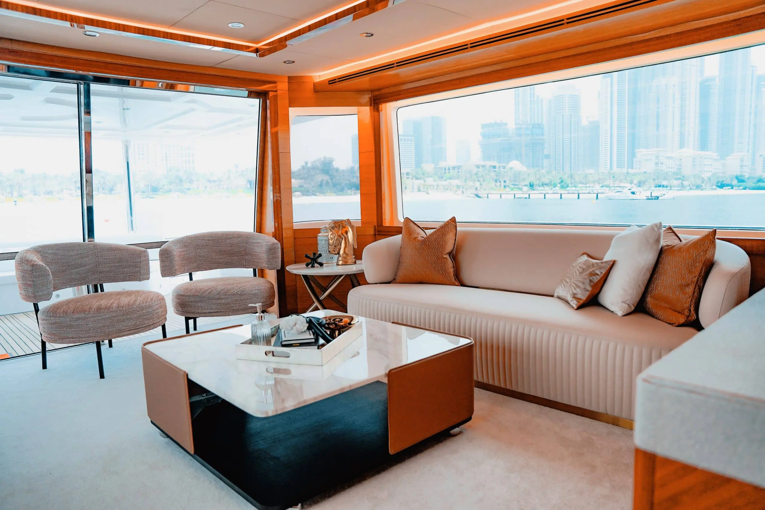 Luxury yacht salon with panoramic windows and Dubai skyline view
