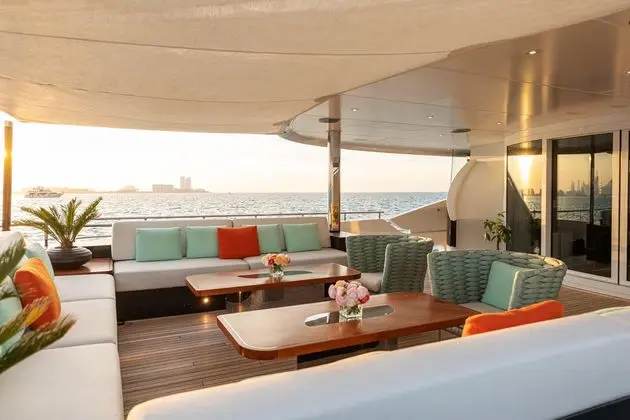 Heesen 5000 bridge deck lounge at sunset, sliding glass doors