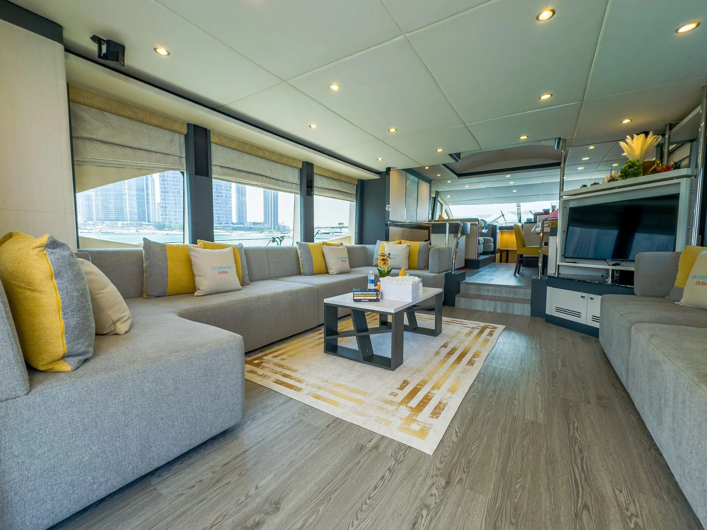 Cabo 77 yacht main salon interior with luxury sofa and modern decor