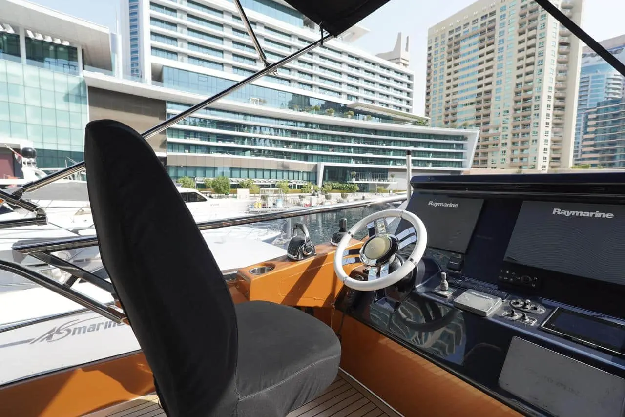Azimut 77 yacht helm station with luxury navigation controls and city marina view
