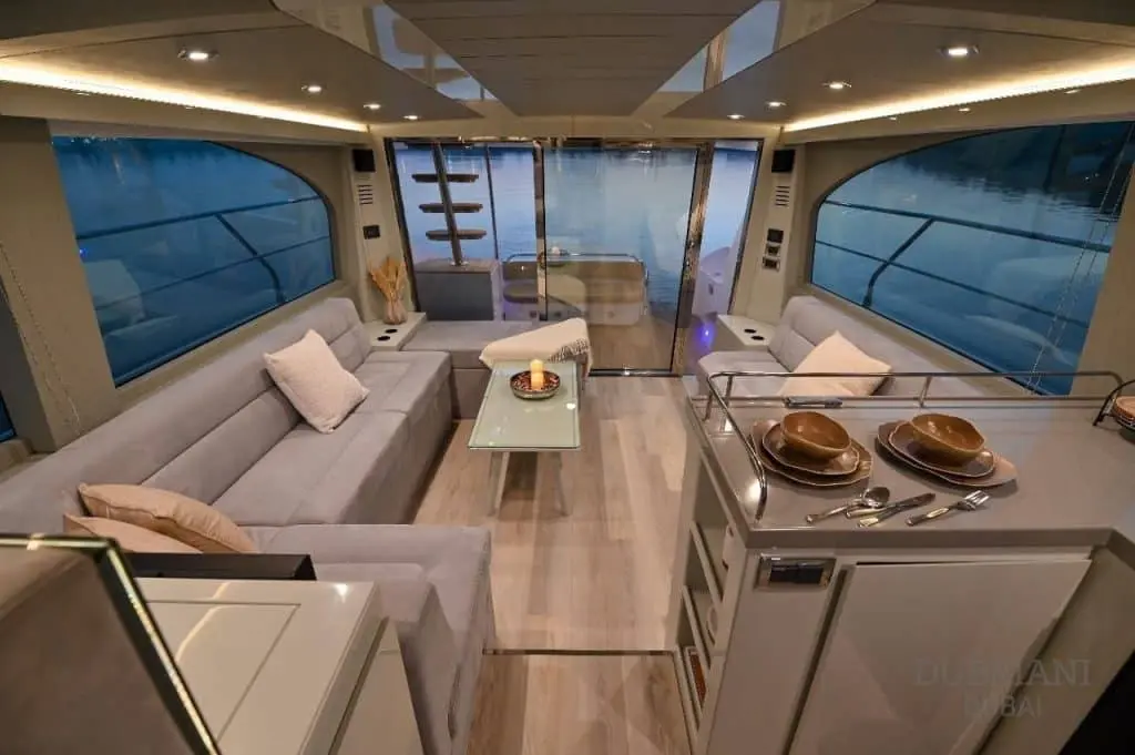 Novia 55 yacht salon in daylight with grey L-shaped sofa and panoramic windows