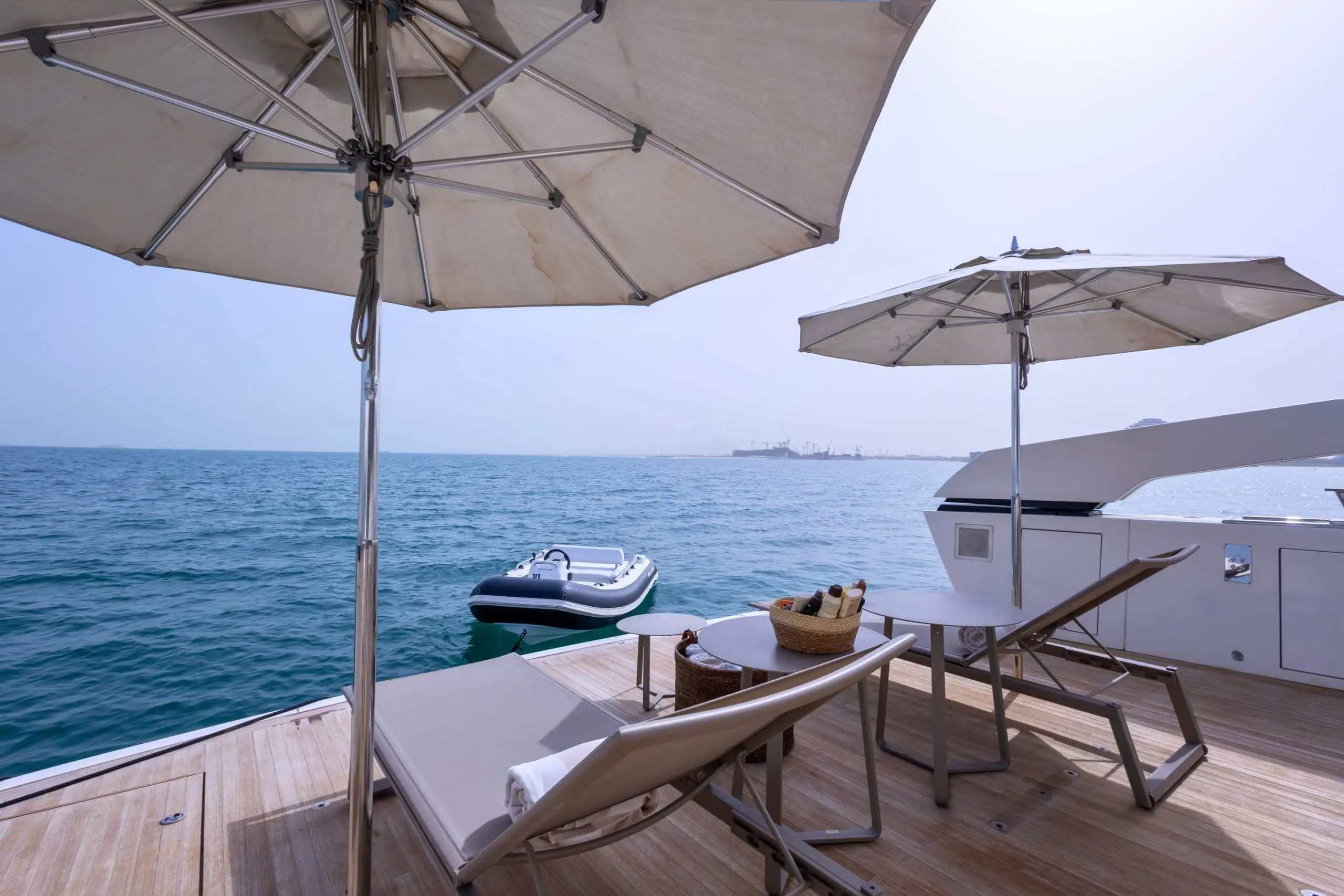 SanLorenzo SX88 beach club sun loungers under umbrellas at anchor