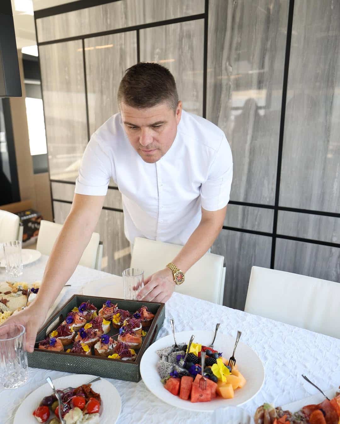 professional chef arranging gourmet dishes for luxury yacht catering