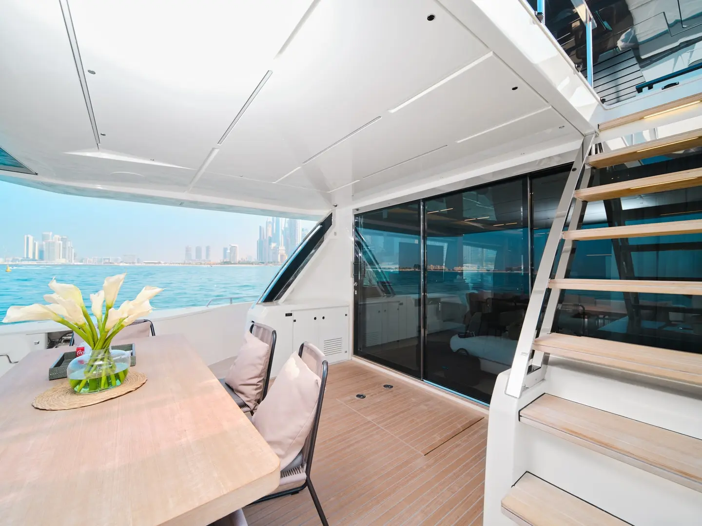 Upper deck lounge area on Ferretti 780 yacht with seating and staircase