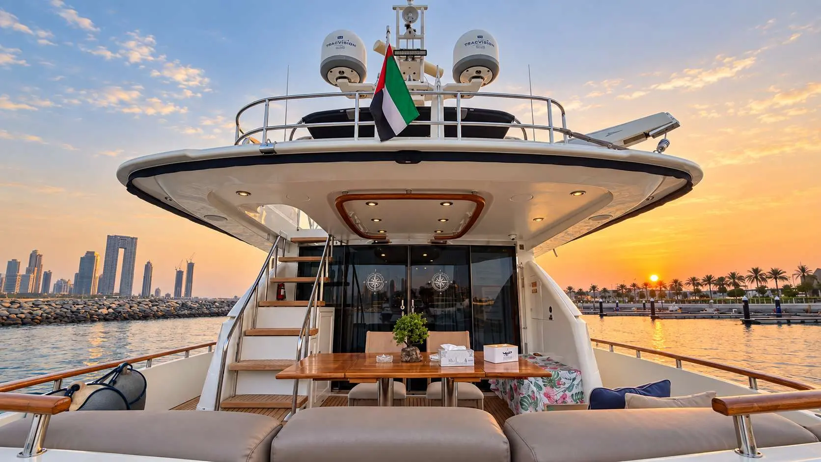 Empress 80 aft deck dining table at sunset with Dubai skyline