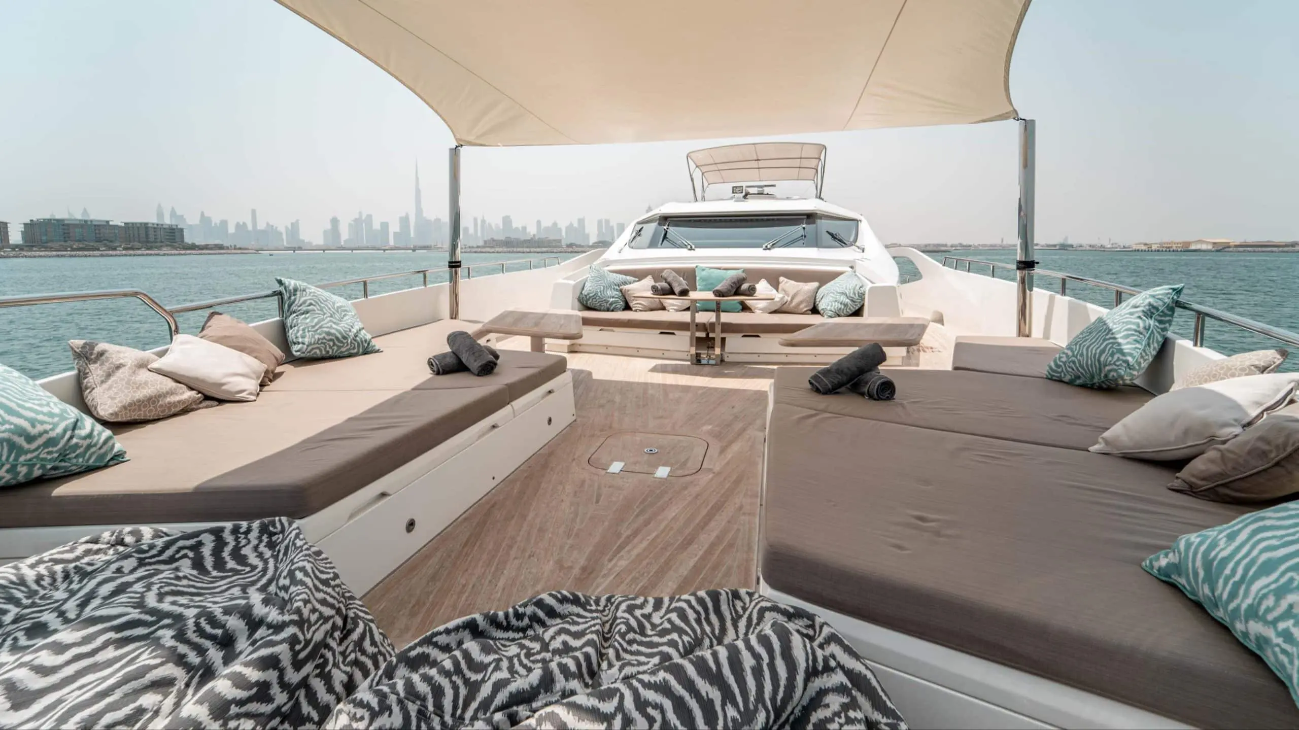 Aft deck lounge area on Dolce Vita yacht with skyline view
