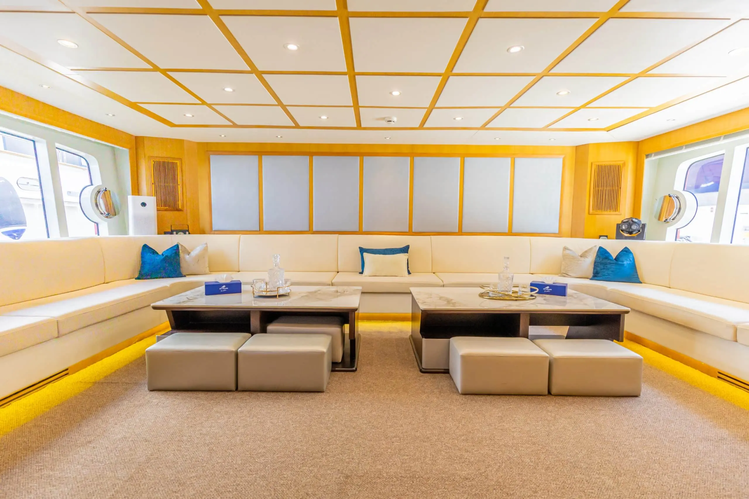 Asya 110 yacht covered deck lounge with white seating and wooden finish