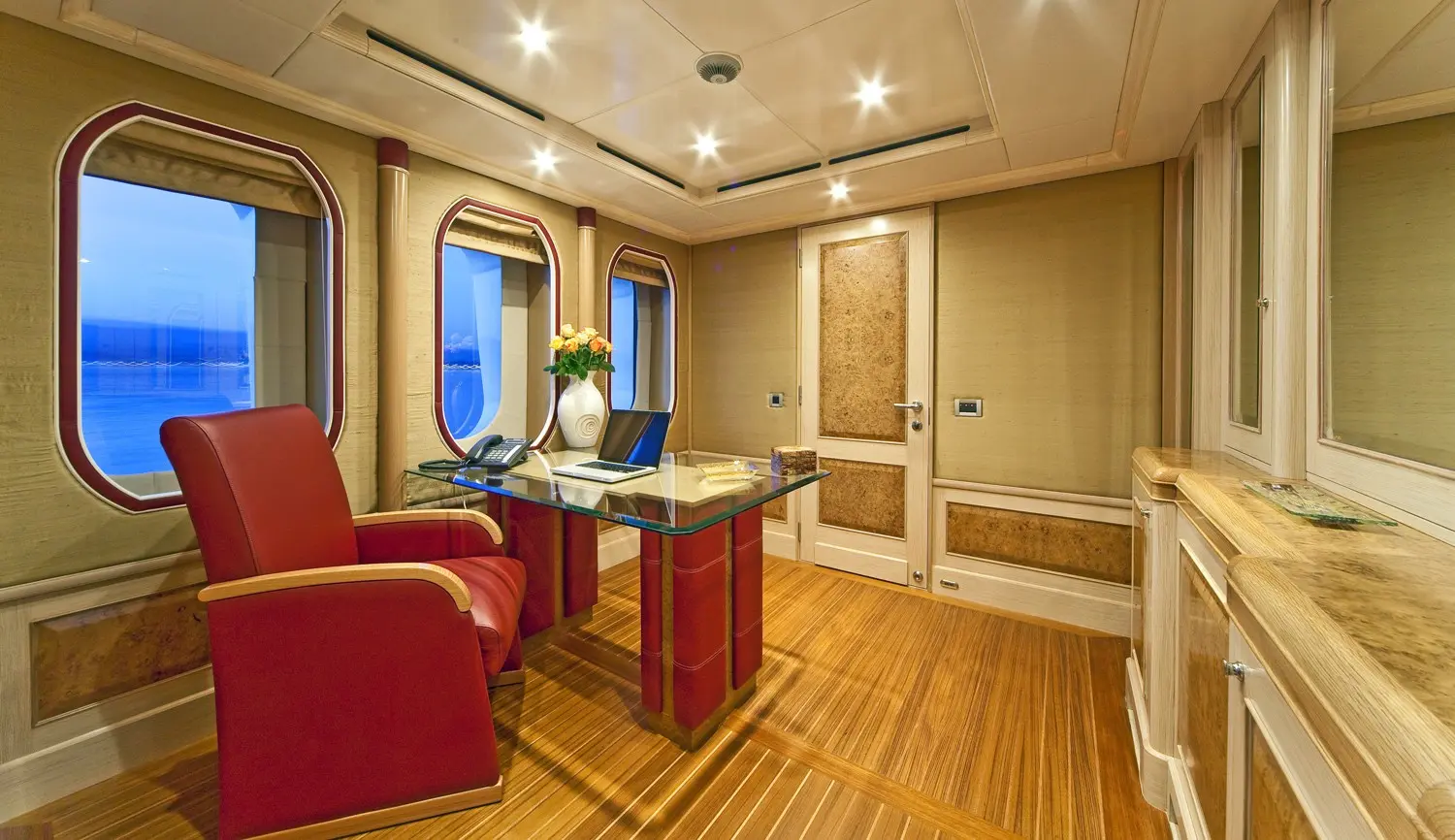 Athena 170 yacht private office with red chairs and executive desk