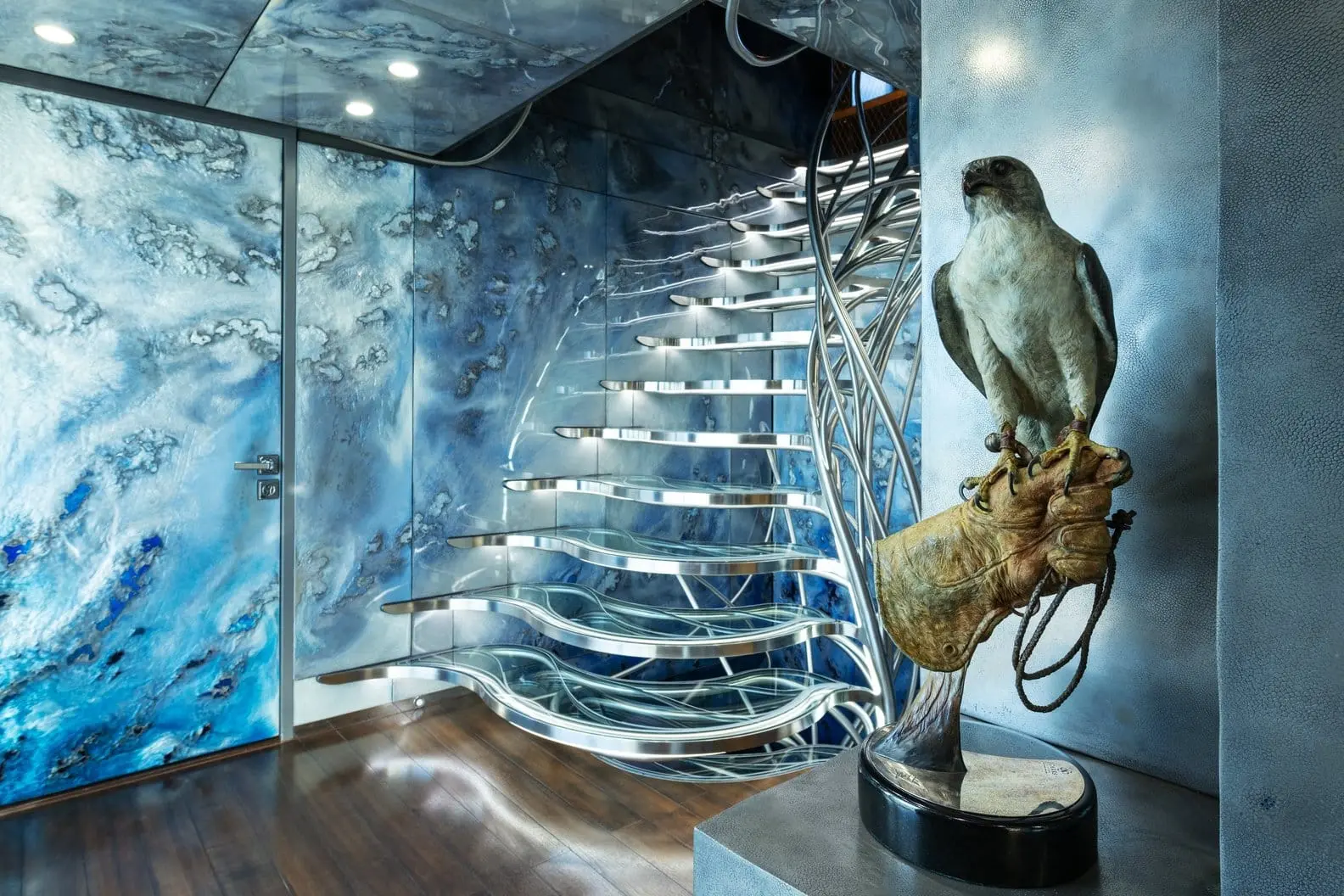 Heesen 5000 sculptural wave staircase with falcon sculpture