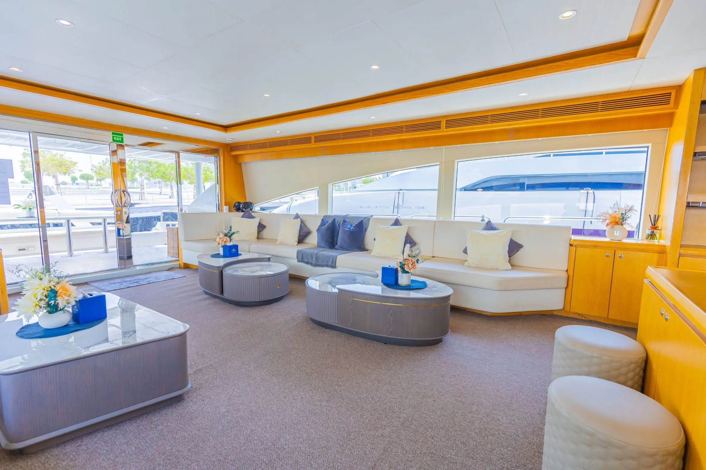 Asya 110 yacht seating area with curved sofa and ocean view